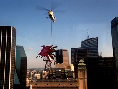 In 1999, workers used a helicopter to lower a crane next to Dallas' historic icon, Pegasus,...