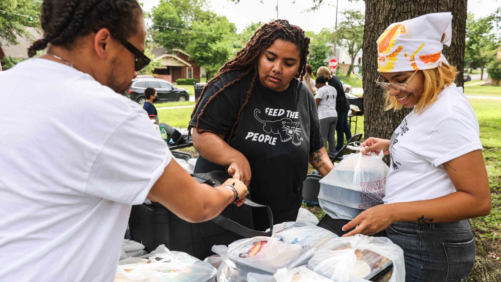 From left, Patrick Averhart, Vanessa Wilmore, Feed the People founder, and Bethany Silva, pack boxes with food to deliver in Dallas on Thursday, June 3, 2021. Feed the People is an initiative that organizes free grocery delivery and resource distribution to those in need based in the metroplex and centered around “solidarity not charity.”