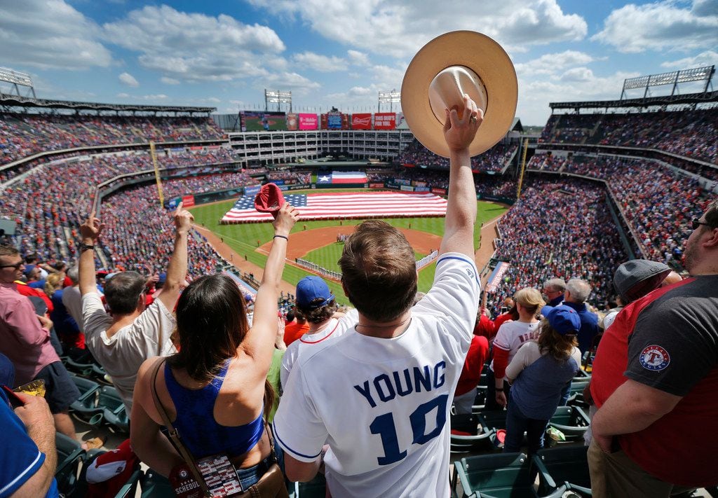 Texas Rangers and Michael Young fan Andrew Brown and his wife Andrea of Plano cheer after...