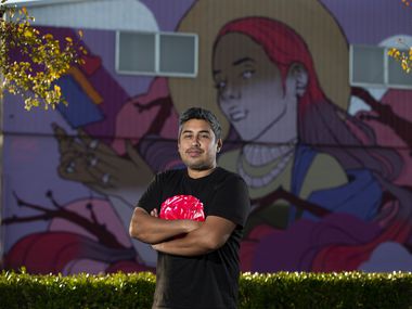 Hatziel Flores posed in front of his mural in West Dallas on Nov. 16, 2021. Street art “welcomes everyone. It never discriminates,” says Flores, a Mexico City-born artist.