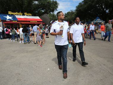 Dennis Jansen (left) and Benjamin Robinson walk around the State Fair of Texas at Fair Park...