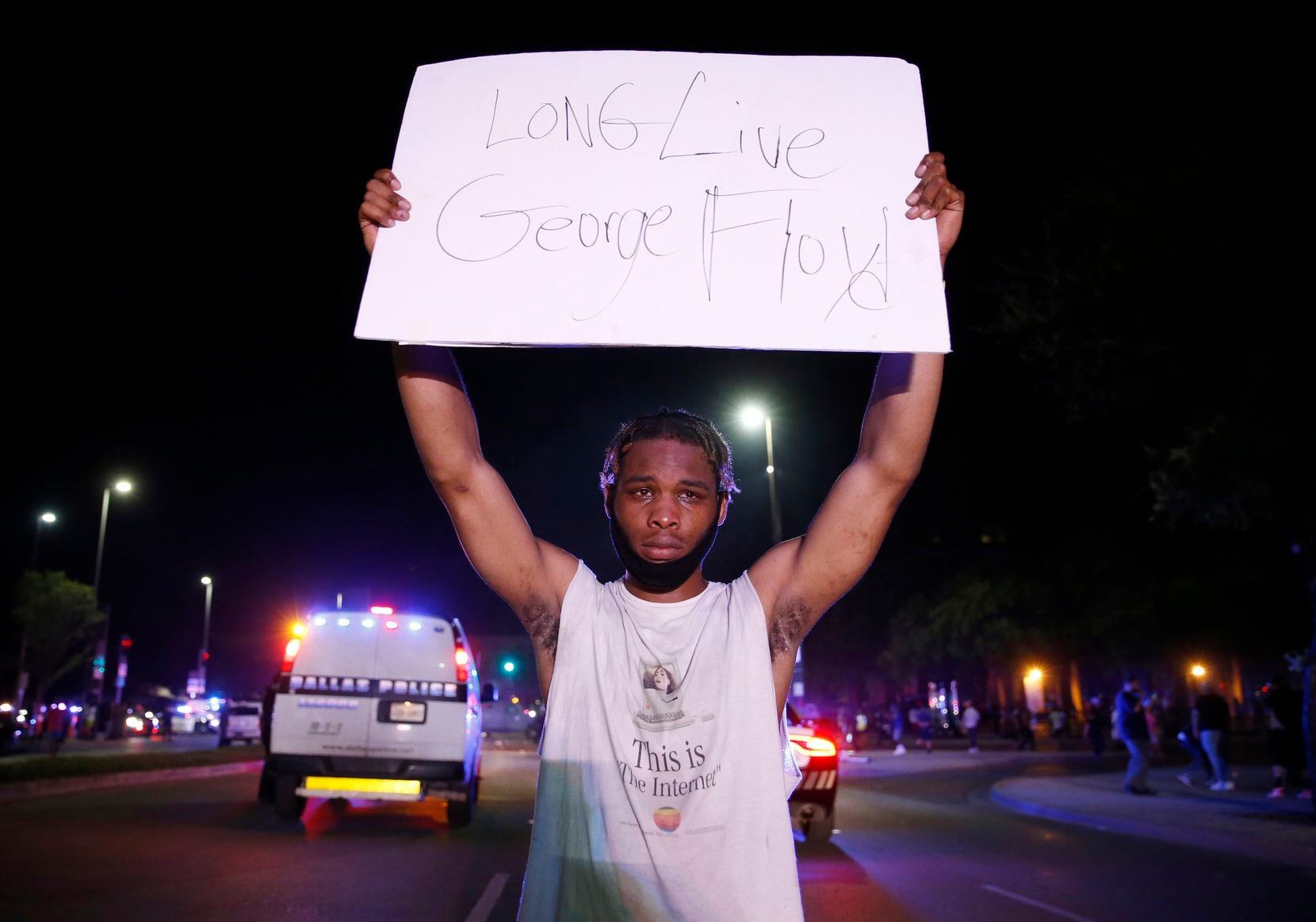 Jordan Spotser of Dallas holds up a sign in front of Dallas police during a demonstration...