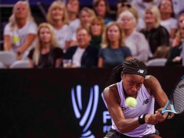 Coco Gauff of the USA plays a backhand shot against Caroline Garcia of France on day two of...