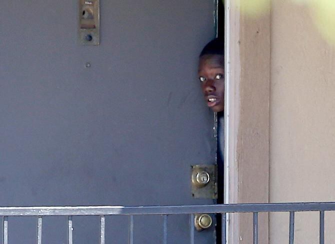
A boy peeked out Oct. 3 from the apartment where Dallas’ first Ebola patient, Thomas Eric...