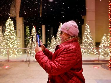 Sylvia Diaz of El Paso was excited about the artificial snow falling as she entered the...