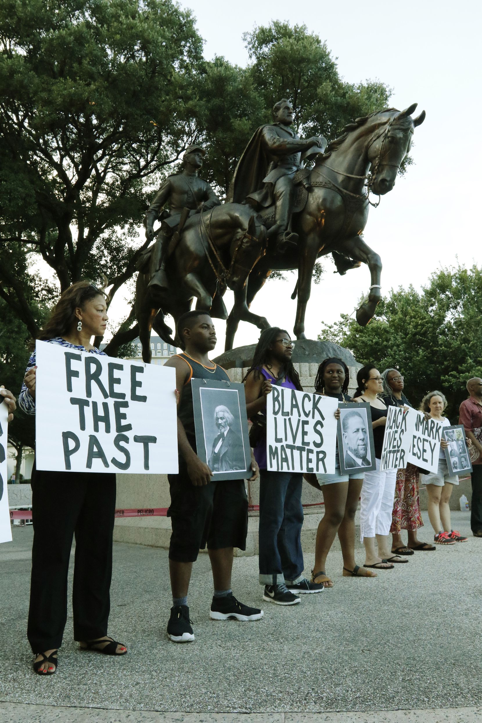 The Dallas Peace Center and Mothers Against Police Brutality hosted a rally at Lee Park in...