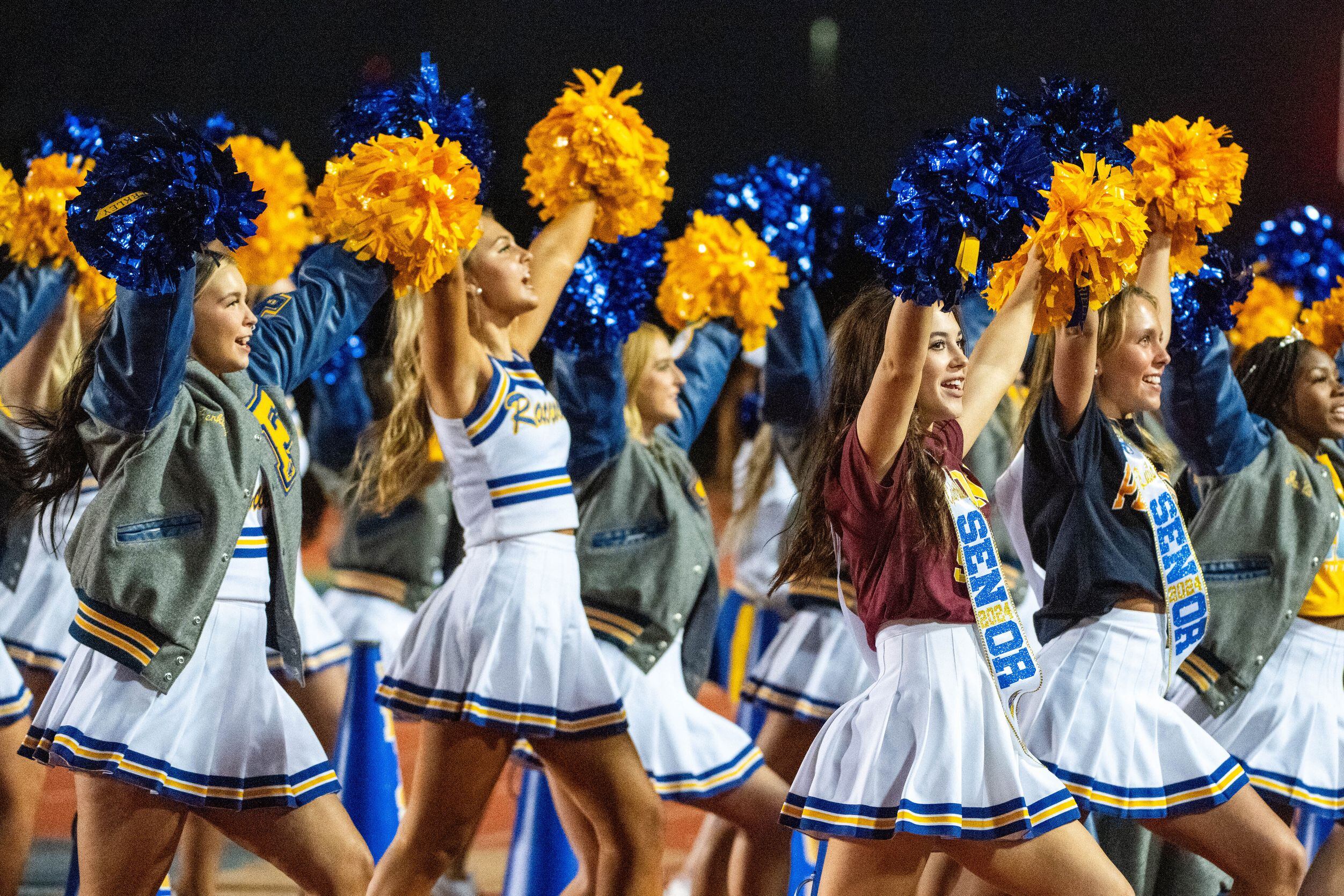 Frisco cheerleaders perform in the first half during a high school football game between...