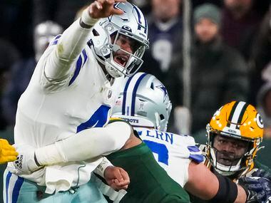 Dallas Cowboys quarterback Dak Prescott (4) throws as he is hit by Green Bay Packers...