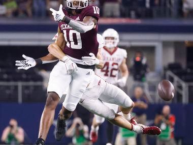 Texas A&M defensive lineman Fadil Diggs (10) misses a pass while getting tackled by Arkansas...