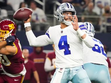 Dallas Cowboys quarterback Dak Prescott (4) throws a pass during the first half of an NFL football game against the Washington football team at AT&T Stadium on Sunday, December 26, 2021 in Arlington.