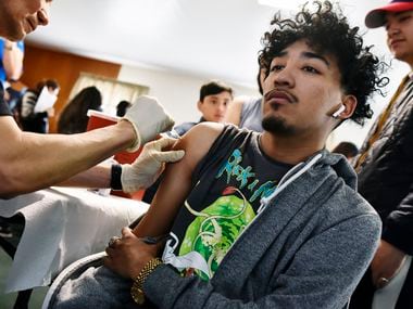 Alan Calvillo received a flu shot during a January health fair in Dallas. The Dallas-Fort Worth region has high health care prices and usage of health services has declined, according to a study of insurance claims.