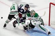 Colorado Avalanche left wing Miles Wood (28) is sandwiched between Dallas Stars defenseman...
