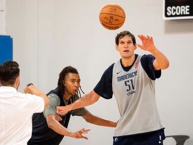 Dallas Mavericks centers Moses Brown, left, and Boban Marjanović (51) compete in a...