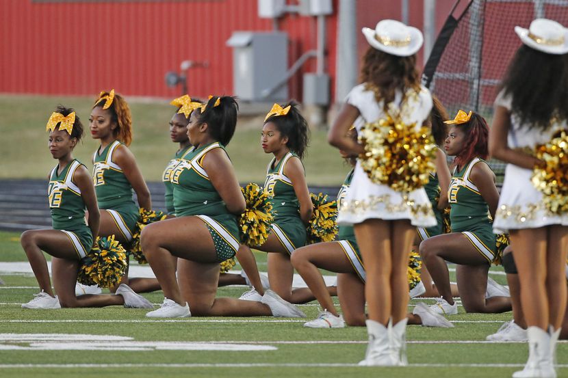 DeSoto cheerleaders take a knee during the playing of the national anthem before the DeSoto...