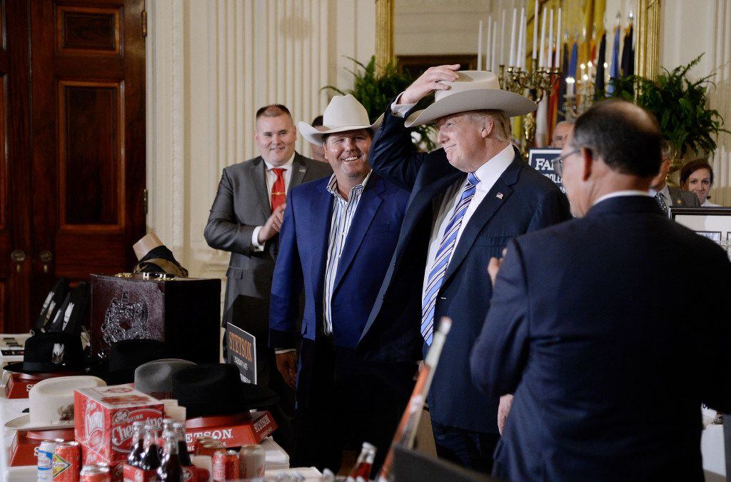 President Donald Trump examines US-made products from all 50 states, including a Stetson...