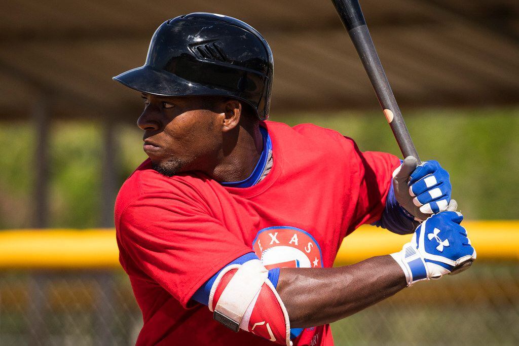 Cuban outfield Julio Pablo Martinez hits in a tryout game during a camp at the Rangers'...