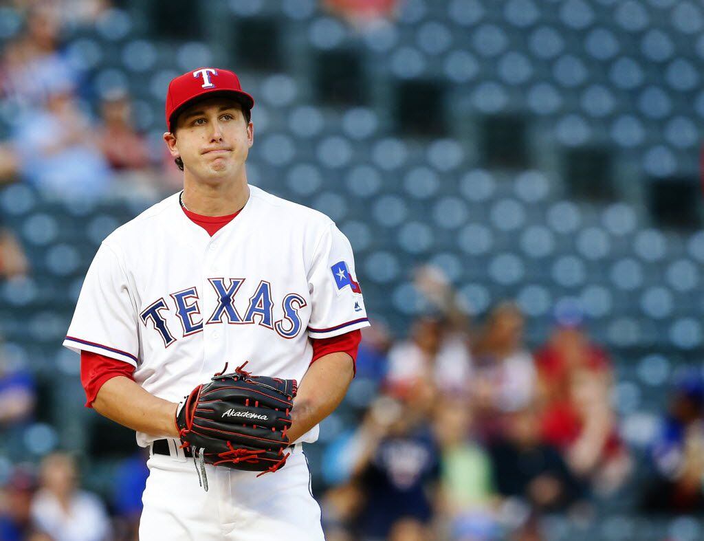 Texas Rangers starting pitcher Derek Holland (45) reacts after a missed strike in the first...