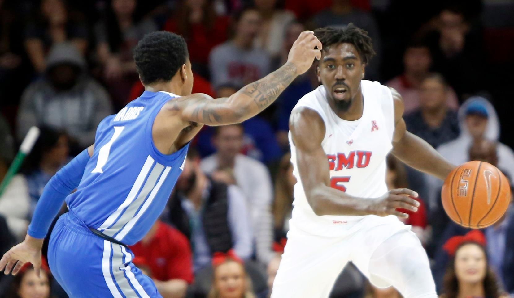 SMU guard Emmanuel Bandoumel (5) looks to drive to the basket as he is defended by Memphis...