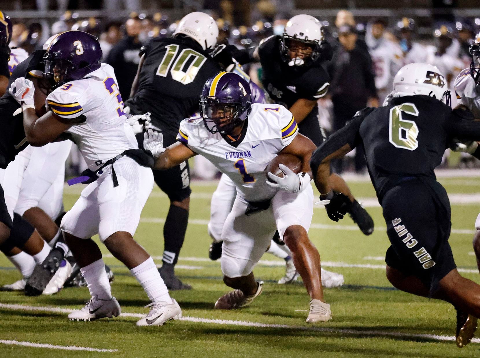 Everman running back Errick Mills takes a direct snap and makes his way through the South...