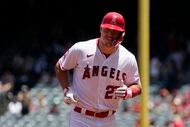 FILE - Los Angeles Angels' Mike Trout smiles as he rounds third after hitting a solo home...