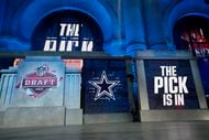 The onstage video screens display "The Pick Is In" for the Dallas Cowboys during the 2023...