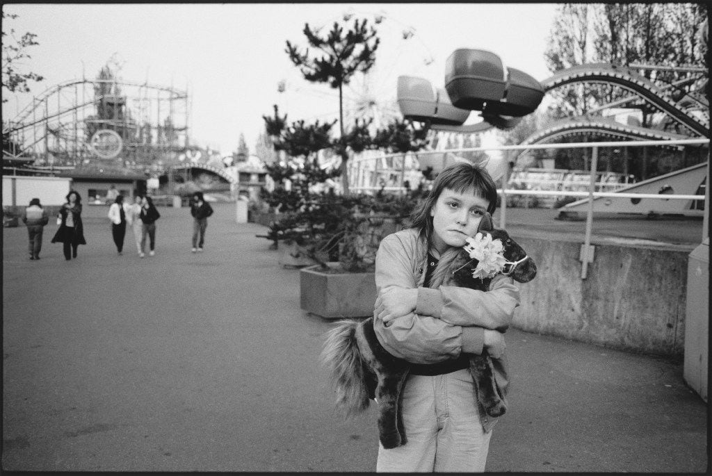 Photos of Tiny, by Mary Ellen Mark. Tiny at the amusement park with
   Horsie,    Seattle, 1983