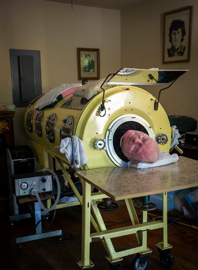 Paul Alexander looks out from inside his iron lung at his home in Dallas.  Now in his 70s,...