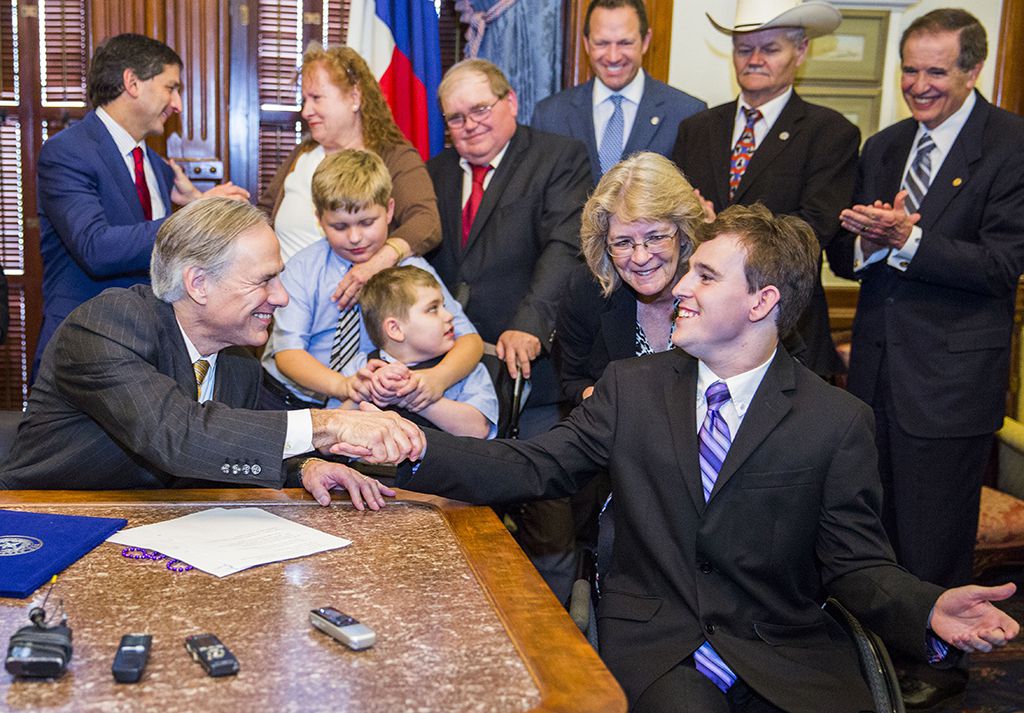  Gov. Greg Abbott and Zachariah Moccia, 25, who has Dravet syndrome during a bill signing...