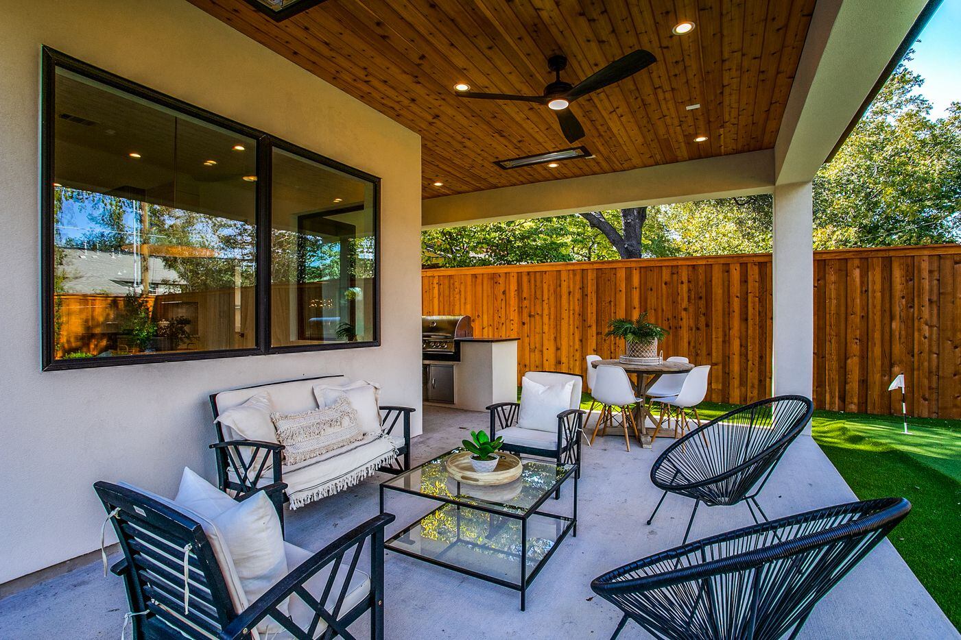 The second patio boasts a seating area and a built-in grill and heaters.