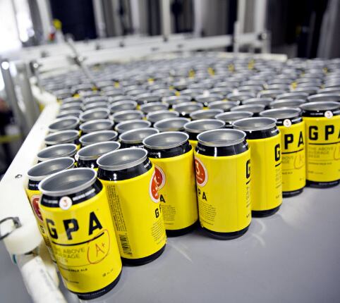 Empty cans are lined on a machine used to can beer at Three Nations Brewing Friday, October...