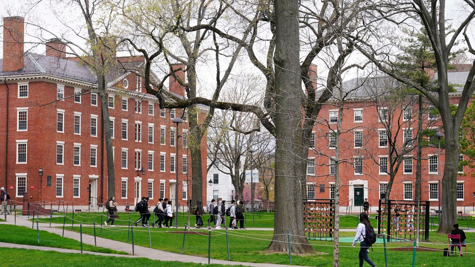 Students walk through Harvard Yard, April 27, 2022, on the campus of Harvard University in...