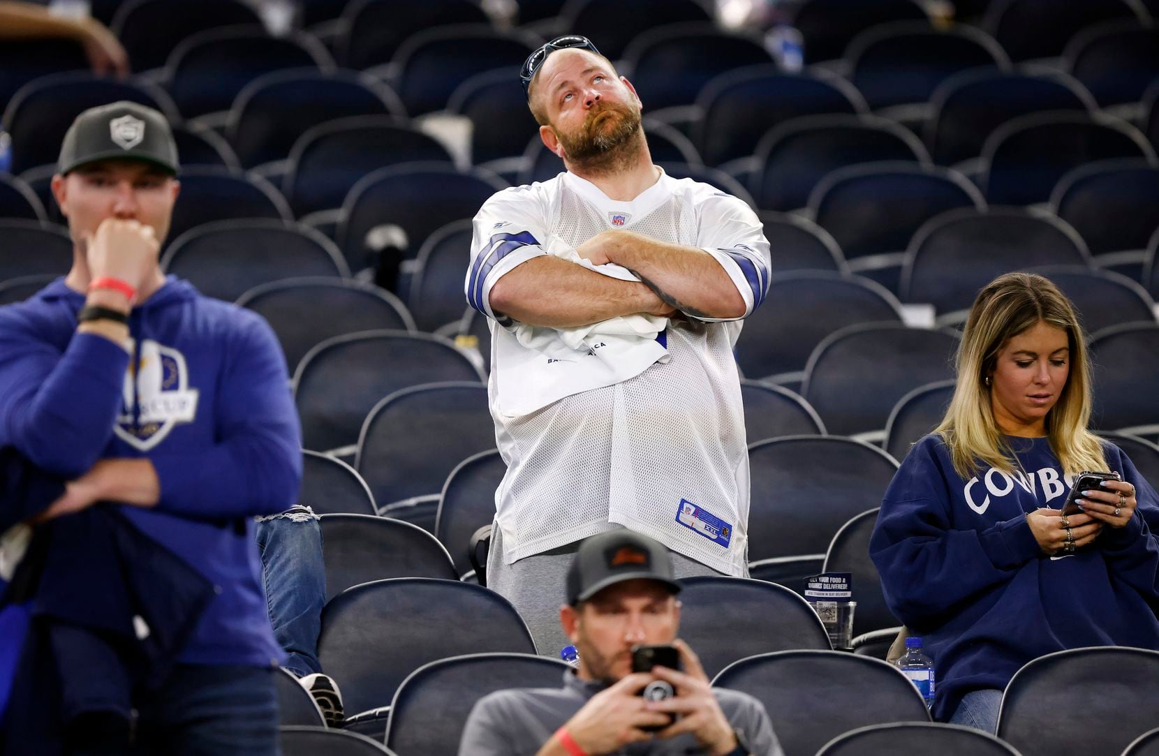 Dallas Cowboys fans react after their team lost to the San Francisco 49ers in the NFL...