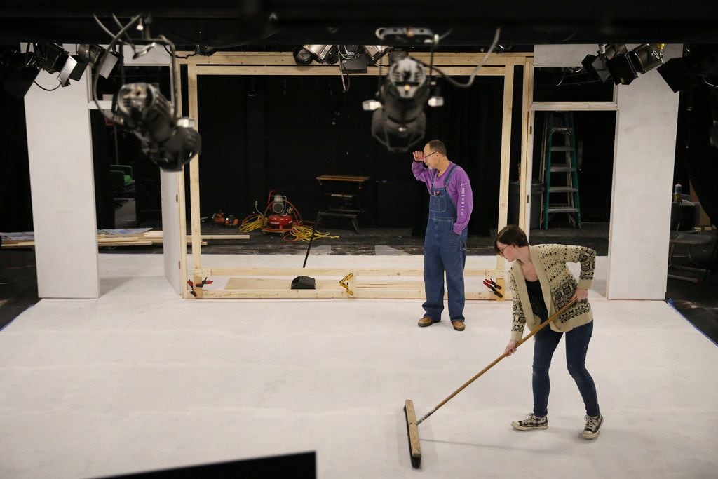 Jeff Mizener (back), assistant master carpenter and technical consultant, looks at the set...