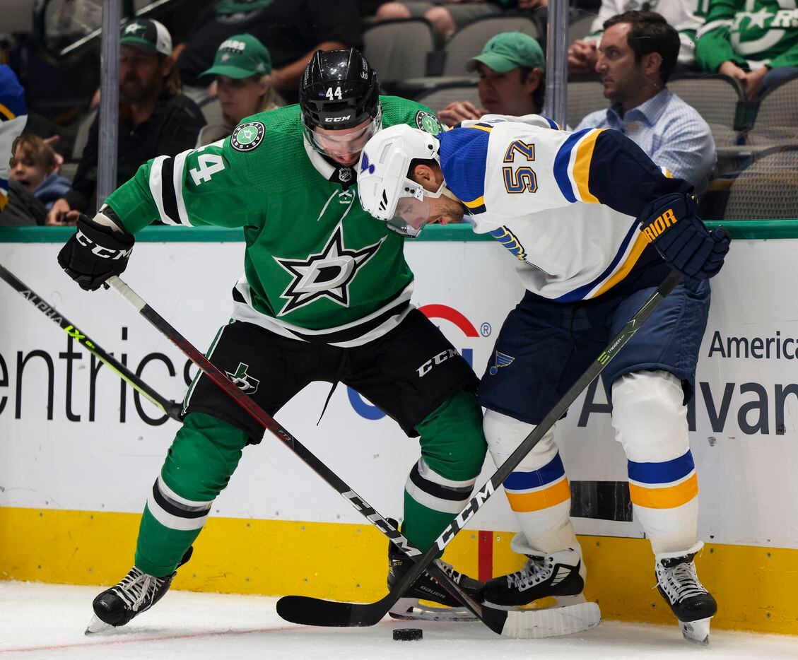 Dallas Stars defenseman Joel Hanley (44) and St. Louis Blues left wing David Perron (57) fight for the puck during the second period of a Dallas Stars preseason game against St. Louis Blues on Tuesday, Oct. 5, 2021, at American Airlines Center in Dallas. (Juan Figueroa/The Dallas Morning News)