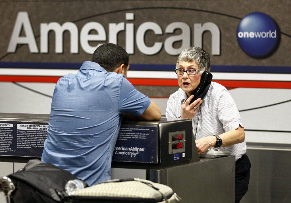 American Airlines agent Catherine Christensen patiently helped a passenger with his flight...