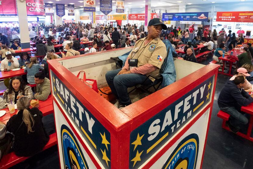 A member of the State Fair of Texas safety team keeps an eye on crowds at the food court...