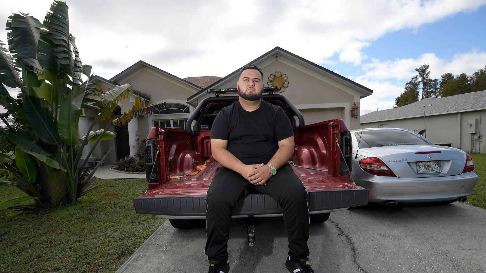 Brandon Gonzales sits on the back of his step-father's truck outside his mother's home in...