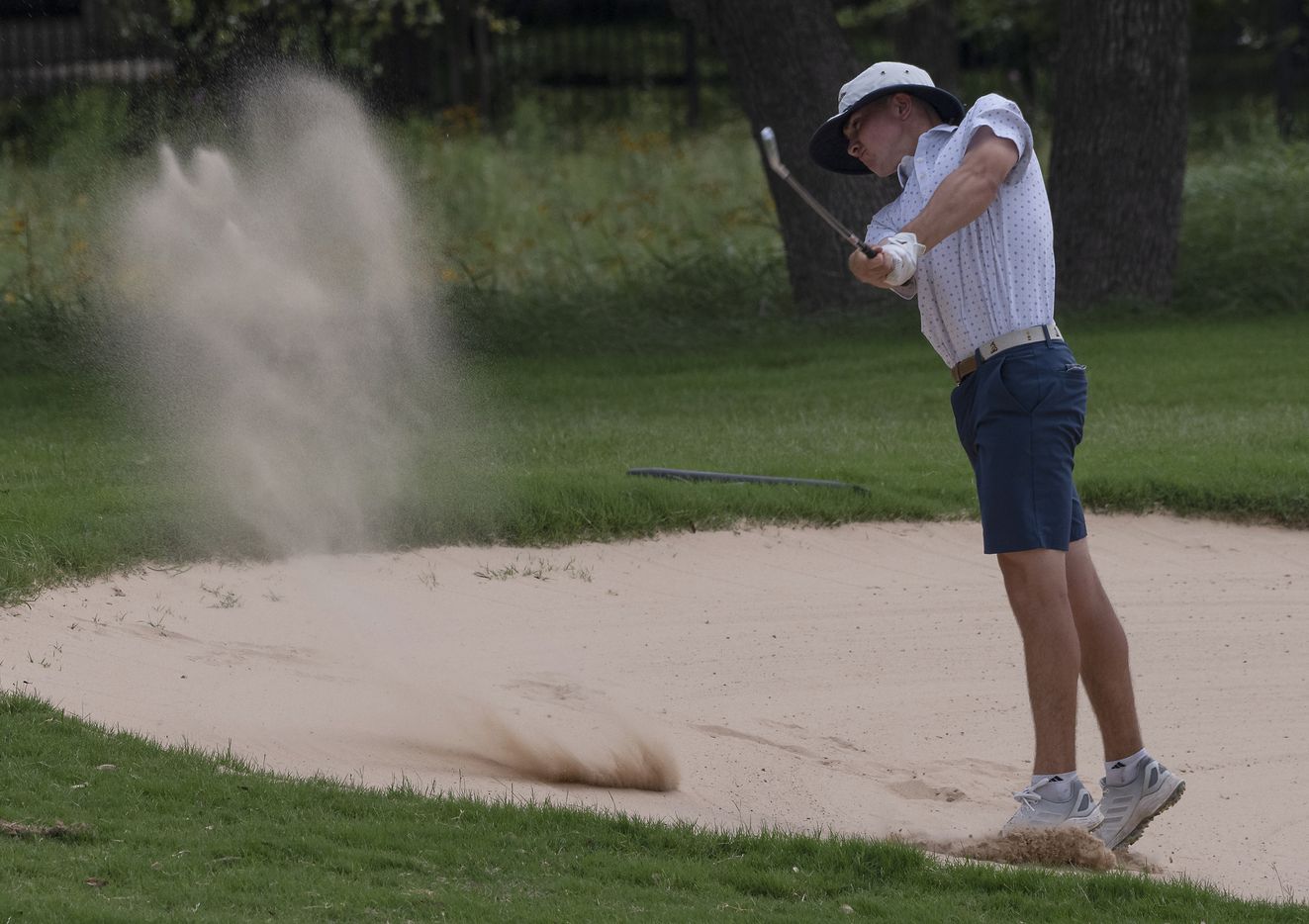 Keller Kaelen Dulany, hits out of a fairway bunker on the 18th hole during the UIL Class 6A...