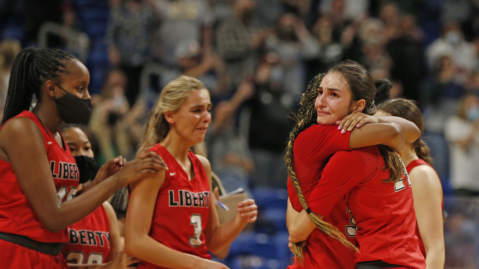 Frisco Liberty Maya Jain #24 hugs Frisco Liberty Jazzy Owens-Barnett #30 at the end of the game. Frisco Liberty vs. Cedar Park in girls basketball Class 5A state championship game on Wednesday, March 11, 2021 at the Alamodome. 
