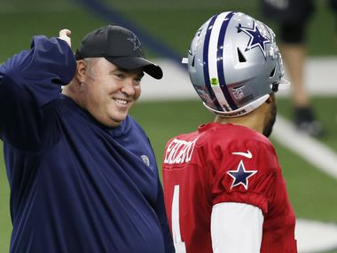 Dallas Cowboys head coach Mike McCarthy smiles as he talks with Dallas Cowboys quarterback Dak Prescott (4) during training camp at the Dallas Cowboys headquarters at The Star in Frisco, Texas on Monday, August 17, 2020.
