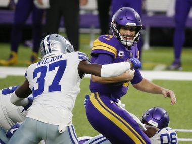 Dallas Cowboys safety Donovan Wilson (37) sacks Minnesota Vikings quarterback Kirk Cousins, right, during the first half of an NFL football game, Sunday, Nov. 22, 2020, in Minneapolis. (AP Photo/Bruce Kluckhohn)