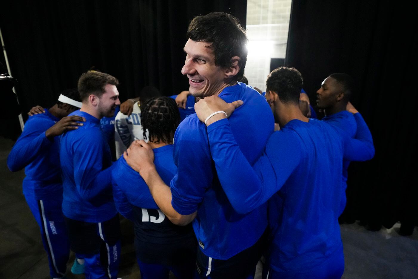 Dallas Mavericks center Boban Marjanovic smiles as the team huddles before Game 2 of the NBA...