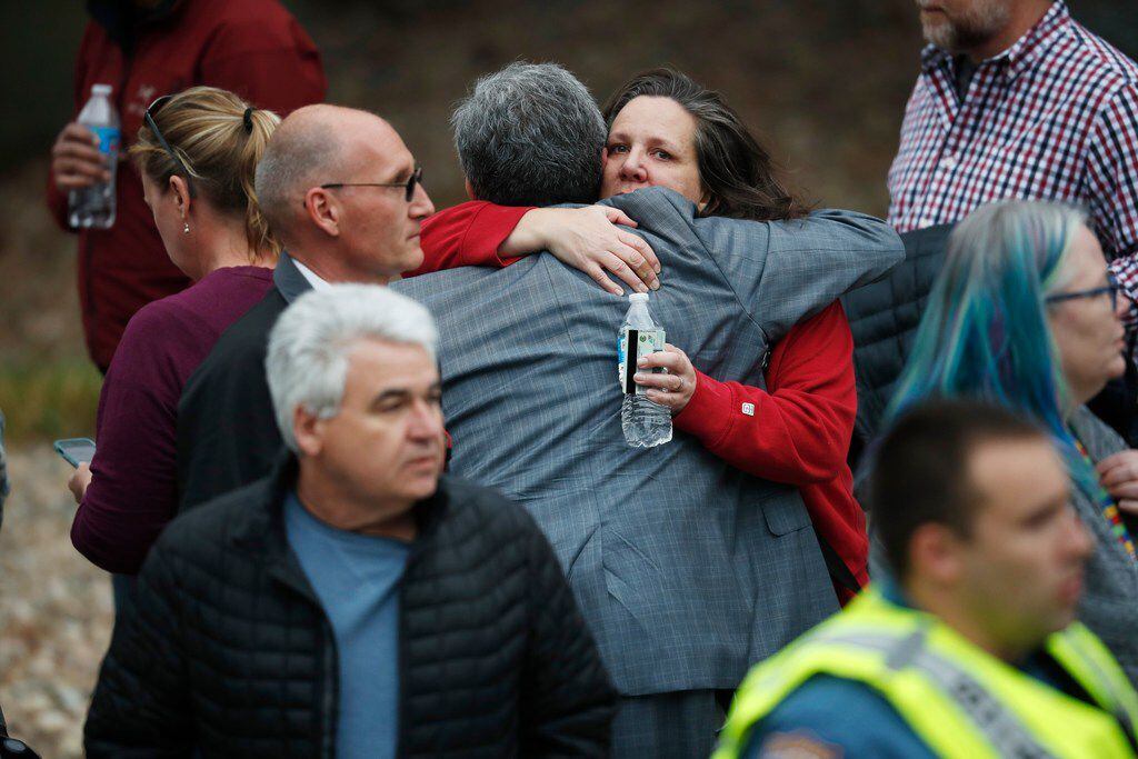 Parents hugged as they waited for their children at a recreation center  in Highlands Ranch,...