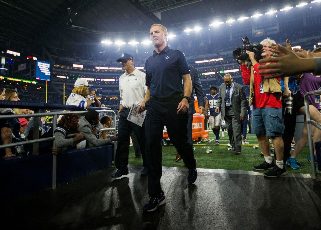Dallas Cowboys head coach Jason Garrett walks off the field after a 28-6 loss at an NFL game...