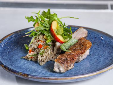 Roots Southern Kitchen's menu includes Peking duck dirty rice with peach salad. Roots is former 'Top Chef' contestant Tiffany Derry's new restaurant in Farmers Branch.