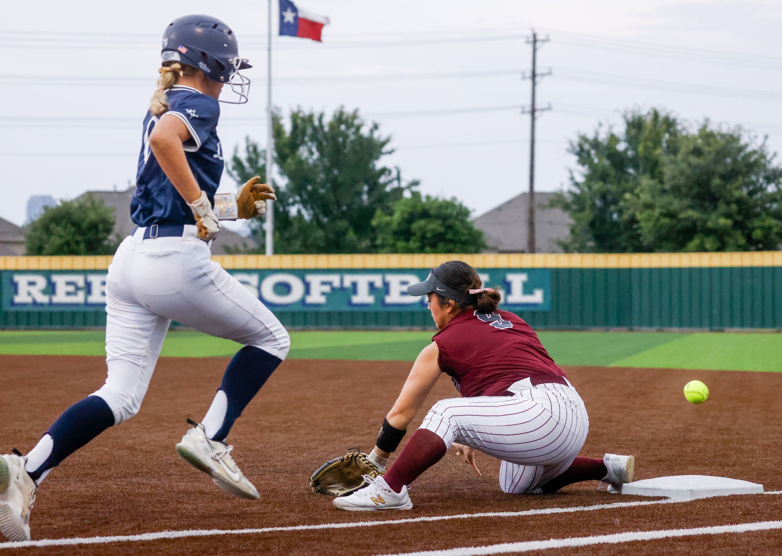 Frisco Lone Star catcher Brooke Wooten (6) runs to first base as the ball bounces by Frisco...