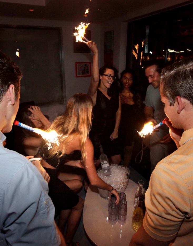 Guests drink and dance at TBD Lounge in Dallas on July 11.