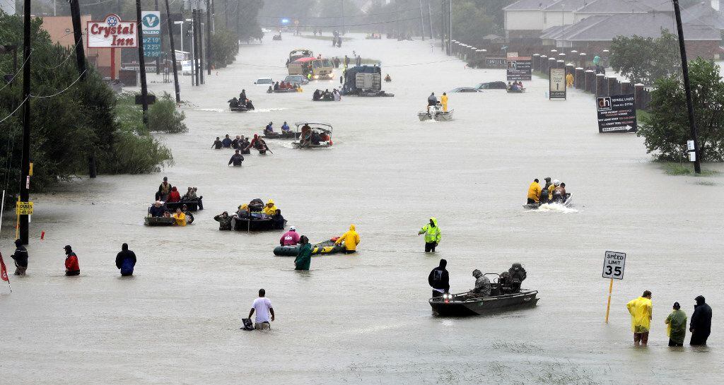 Rescue boats filled a flooded Houston street on Aug. 28. (David J. Phillip/The Associated...