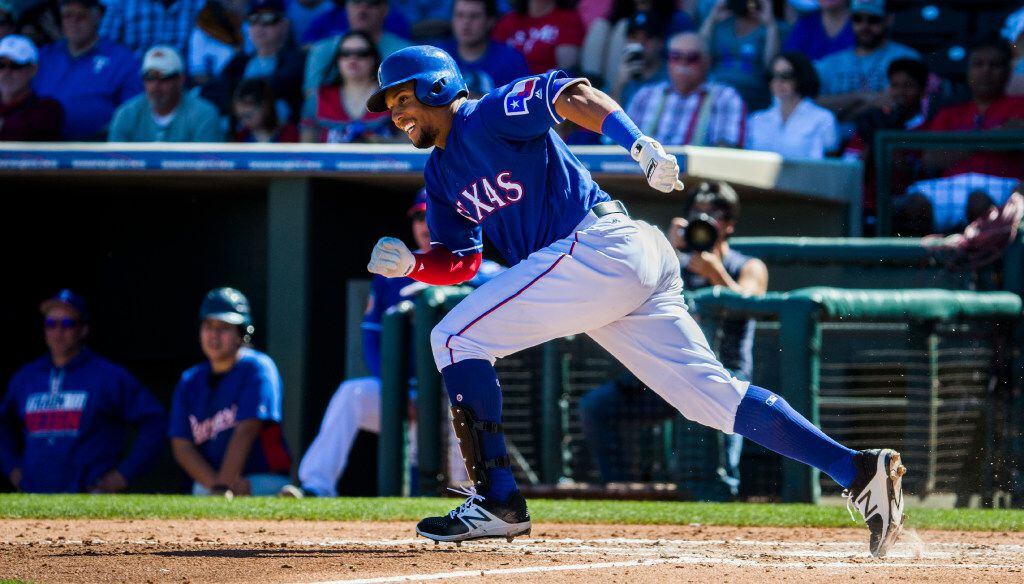 Texas Rangers center fielder Carlos Gomez (14) runs to first base after a hit during the second inning of a spring training game against the Colorado Rockies on Tuesday, March 7, 2017 at the Ranger's spring training facility in Surprise, Arizona. (Ashley Landis/The Dallas Morning News)