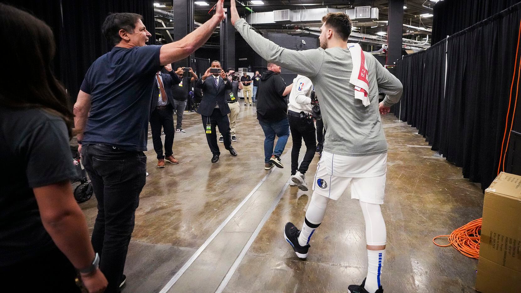 Dallas Mavericks guard Luka Doncic celebrates with team owner Mark Cuban as he leaves the...